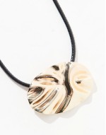 necklace with textured circle pendant and cord design in gold tone